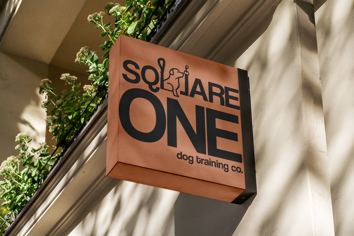 Square One dog training co. logo on a wooden sign for a building