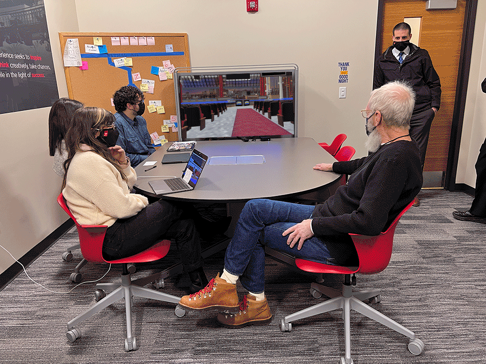 A team of students sit with David Letterman at a table showing him Brandi Geister's virtual reality tour of the Ed Sullivan Theater